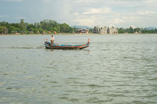 Burmese fishermen in small fishing boats near U-Bein Bridge, in Taungthaman Lake near Amarapura, close to city of Mandalay in Myanmar, Burma, SE Asia