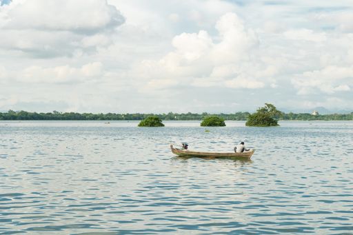 Burmese fishermen in small fishing boats near U-Bein Bridge, in Taungthaman Lake near Amarapura, close to city of Mandalay in Myanmar, Burma, SE Asia