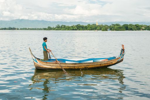 Burmese fishermen in small fishing boats near U-Bein Bridge, in Taungthaman Lake near Amarapura, close to city of Mandalay in Myanmar, Burma, SE Asia