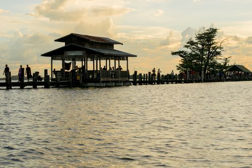 View of U-Bein bridge, built of teak wood, during sunset, in Taungthaman Lake near Amarapura, close to the city of Mandalay in Myanmar, Burma, SE Asia