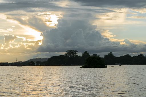 View of Taungthaman Lake near Amarapura, close to Mandalay in Myanmar, Burma, as seen from U-Bein Bridge, before sunset on a cloudy day during monsoon