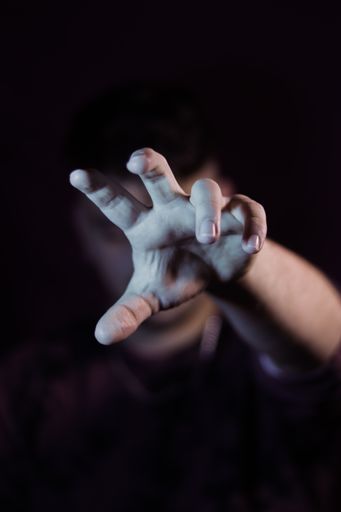 A vertical shot of a man's hand reaching forward