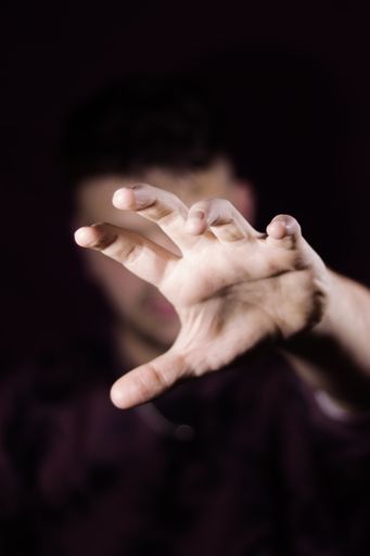 A vertical shot of a man's hand reaching forward