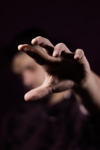 A vertical shot of a man's hand reaching forward