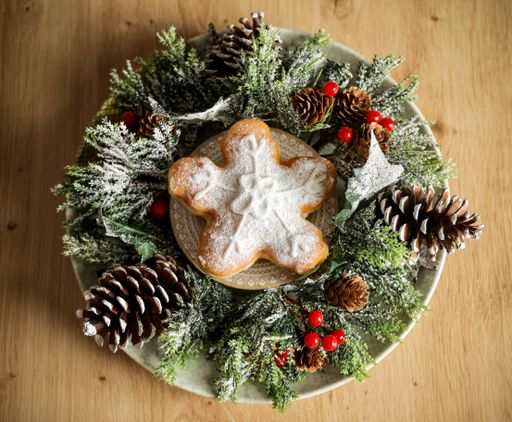 A closeup of star-shaped donuts decorated in Christmas style on a plate