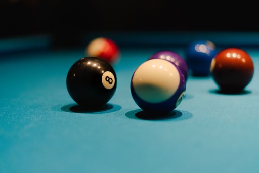 A closeup shot of billiard balls in a green pool table