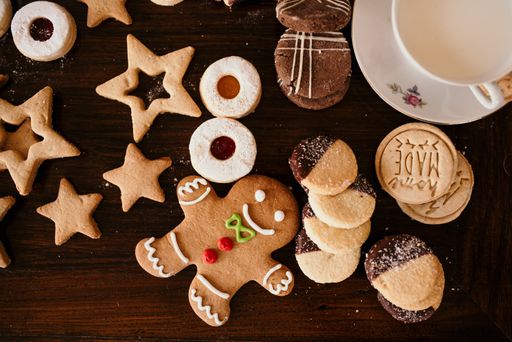 A top view shot of a table full of festive cookies and a cup on Christmas