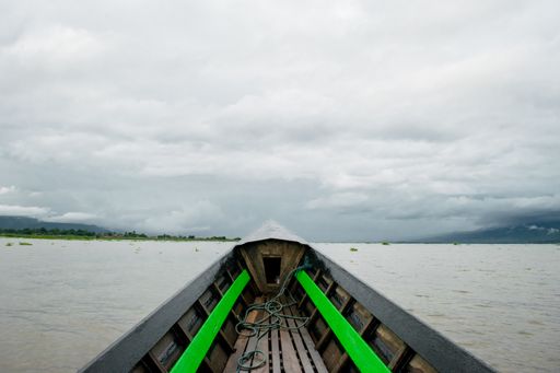 First person view while travelling on a Burmese long boat in Inle Lake, Shan Region, Myanmar, during monsoon season on a cloudy day, Burma, SE Asia
