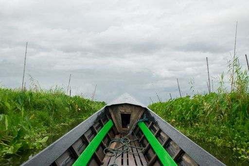 First person view while travelling on a Burmese long boat in Inle Lake, Shan Region, Myanmar, during monsoon season on a cloudy day, Burma, SE Asia