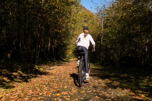 A cyclist woman in forests of the French Pyrenees