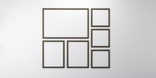 An empty wall with blank picture frames