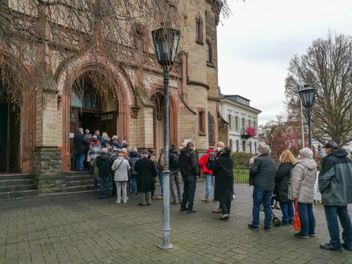 Neuwied, Germany - December 15, 2021: a queue in front of the portal of a church waiting for booster vaccination against Corona virus