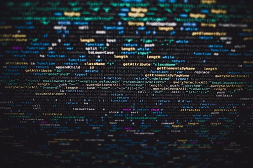 A selective closeup shot of data codes on a black computer monitor screen