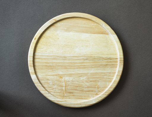 A top view of an empty wooden plate