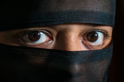 A closeup shot of an Indian woman looking into the camera