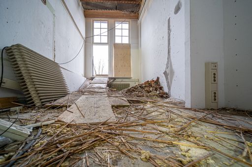 An old demolished building with debris, rubble, and waste