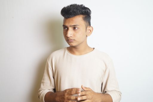 A portrait of a young Indian guy on a white background