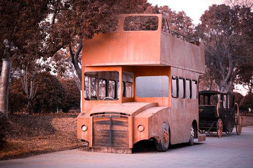 A red old abandoned bus on an empty street in China