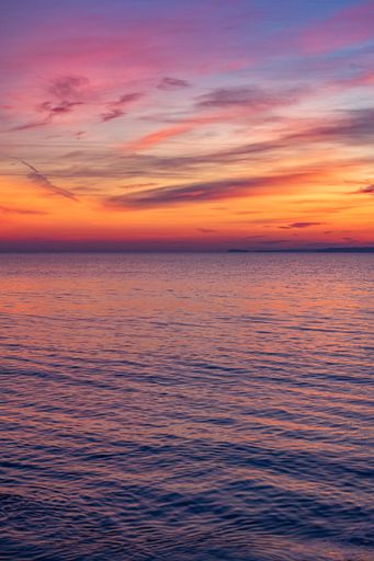 A beautiful shot of an ocean in the sunset time of the day.