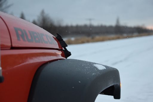 Sax, Minnesota, USA - December 31, 2014 - Jeep Wrangler Rubicon stopped on a snowy road on a cloudy day
