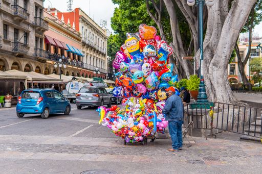 A beautiful shot of a man selling balloons in the historic center in Puebla, Mexico