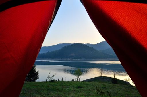A scenic view of a lake from a tent