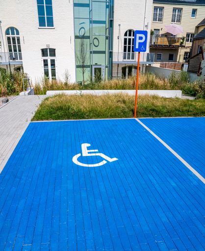 A view of parking space for disabled persons against buildings
