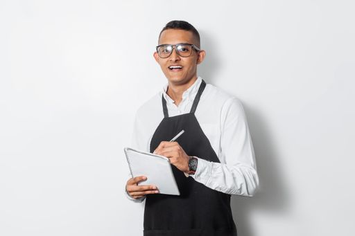 A Hispanic waiter man using a notepad isolated on white background