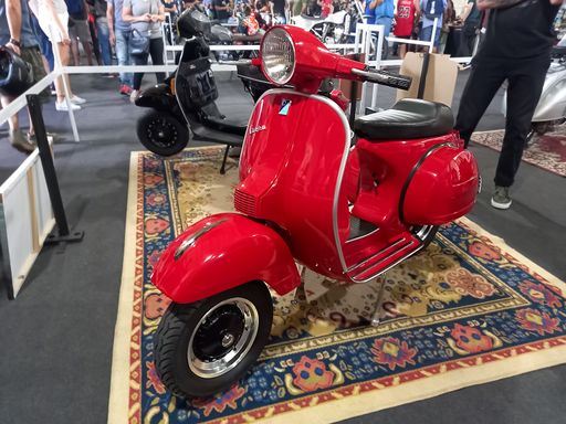 shot of a classic Italian red Vespa P scooter by Piaggio. Expo Wheels 2021 motorbikes show.