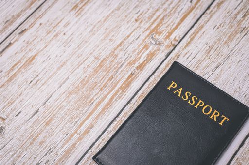 A passport cover on a wooden surface with copy space.