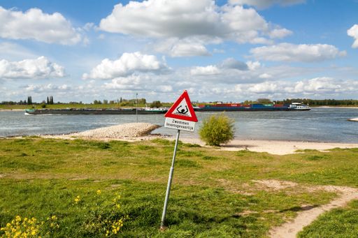Odd road sign along the Waal river in Zaltbommel, Gelderland. Dangerous swimming (in Dutch) and risk of drowning