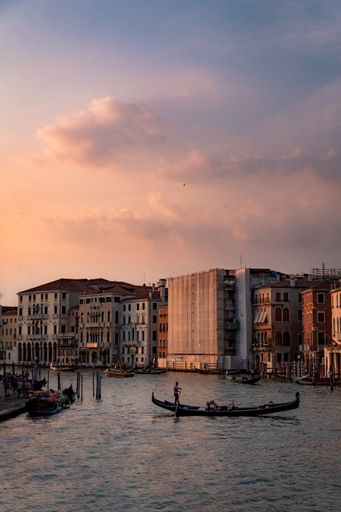 A vertical shot of gondolas on the water captured in the Grand Canal, Venice, Italy
