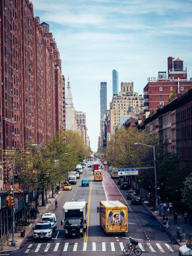 A vertical shot of streets in New York City with the buzz of busy life with skyscrapers, United States