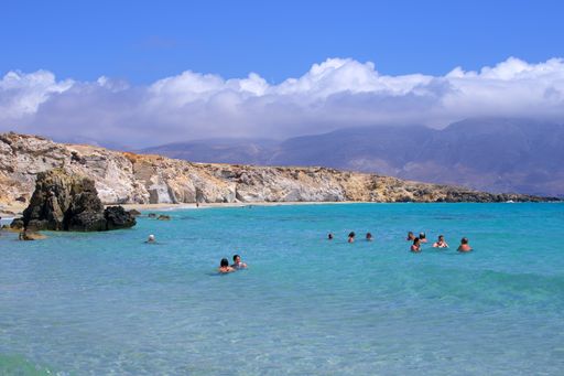 A beautiful view of people swimming in the sea on a sunny day