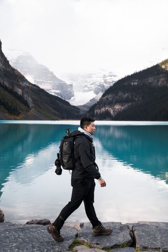 A closeup of a person walking near the lake