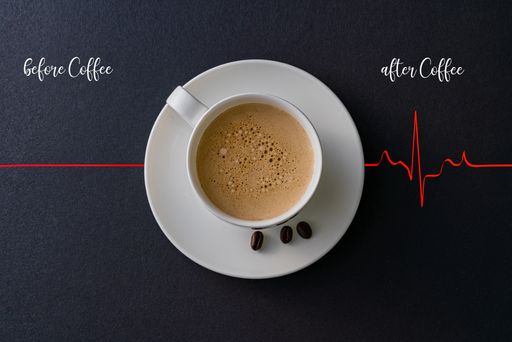 A closeup shot of a cup of coffee with a red heartbeat cardiogram with "before coffee" and "after coffee" writings