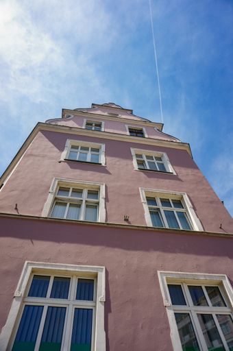 A low angle shot of the residential building under a blue sunny sky
