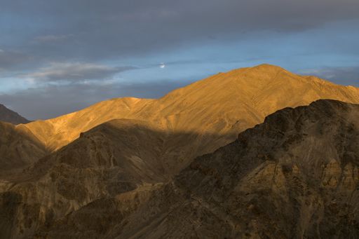 An aerial shot of a beautiful mountain landscape on a cloudy sky background
