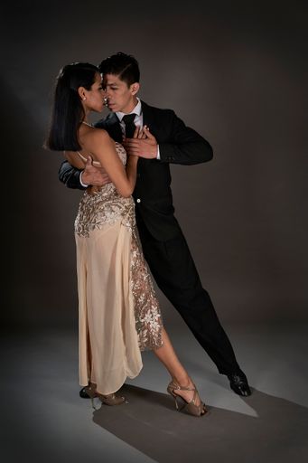 A passionate couple dancing the tango on a black background