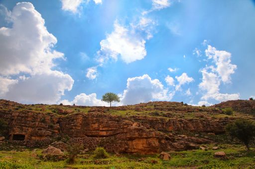A beautiful shot of high hills under the cloudy sky at daytime