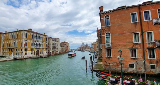 A beautiful scenery of apartment buildings and a canal under a cloudy sky in Venice, Italy