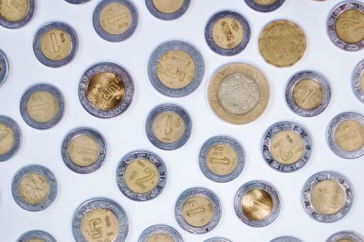 A close-up shot of various old coins on a white background