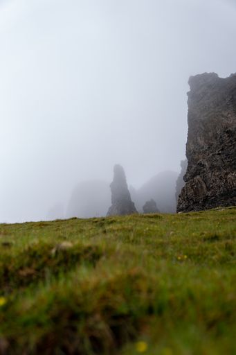 A selective focus shot of cliffs against a grey sky background