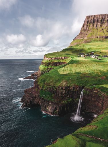 An aerial view of Mulafossur Waterfall in Gasadalur Faroe Islands