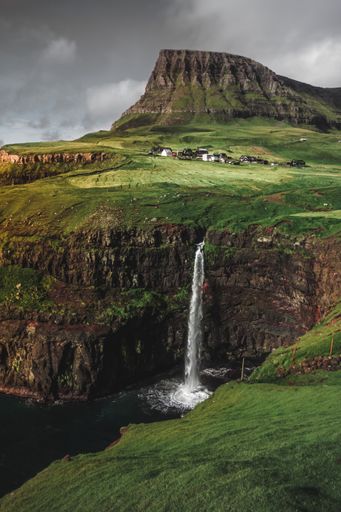 The most famous landmark of the Faroe Islands, a waterfall flowing down over the cliffs in the ocean