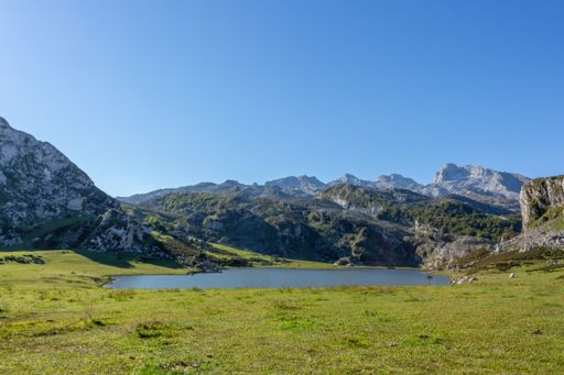 A closeup of the glacial Lake Ercina nestled among marvelous mountain tops in Spain