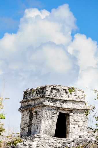 Detail of one of the temples located near the beach in Tulum, Mexico, with some clouds in the background