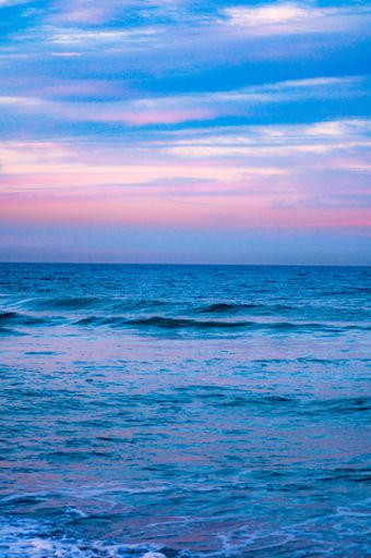 A beautiful shot of the waves of the ocean glowing under the blue sky - great for wallpapers