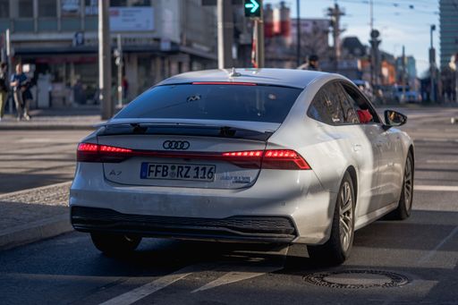A back shot of a sporty gray Audi A6 stands at the traffic lights in Munich. Luxurious car in Germany