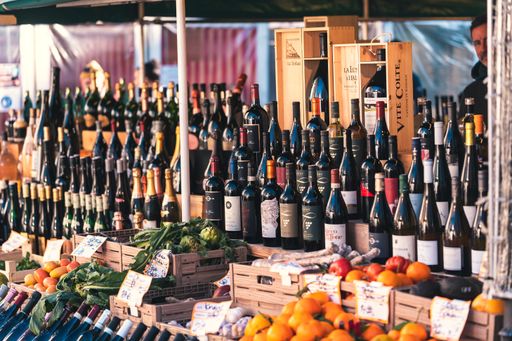 A beautiful shot of a wide range of wine bottles is offered at the market in Munich, Germany